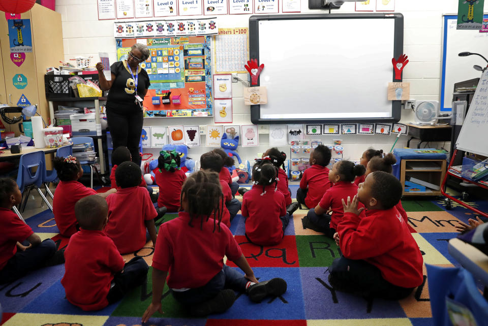 In this Tuesday, Dec. 18, 2018 photo, Michelle Garnett teaches a pre-kindergarten class at Alice M. Harte Charter School in New Orleans. Charter schools, which are publicly funded and privately operated, are often located in urban areas with large back populations, intended as alternatives to struggling city schools. (AP Photo/Gerald Herbert)