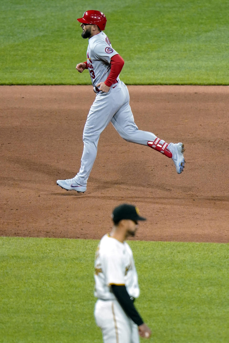 St. Louis Cardinals' Matt Carpenter, top, rounds second after hitting a three-run home run off Pittsburgh Pirates relief pitcher Duane Underwood Jr., bottom, during the sixth inning of a baseball game in Pittsburgh, Friday, April 30, 2021. (AP Photo/Gene J. Puskar)