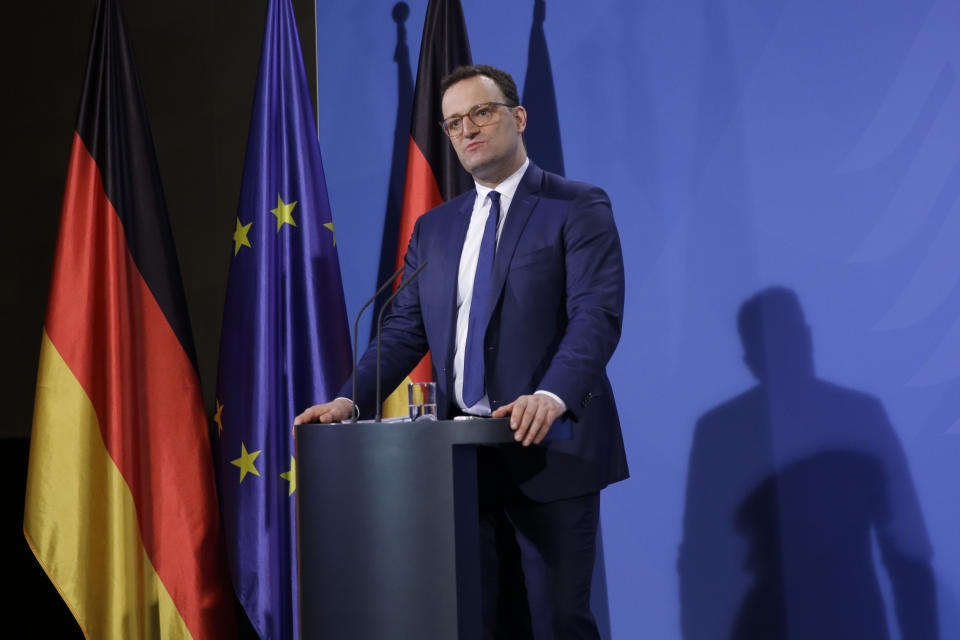 German Health Minister Jens Spahn briefs the media with German Chancellor Angela Merkel after a virtual meeting with federal state governors at the chancellery in Berlin, Germany, Tuesday, March 30, 2021. German health officials agreed Tuesday to restrict the use of AstraZeneca's coronavirus vaccine in people under 60 amid fresh concern over unusual blood clots reported from those who received the shots. (AP Photo/Markus Schreiber, pool)