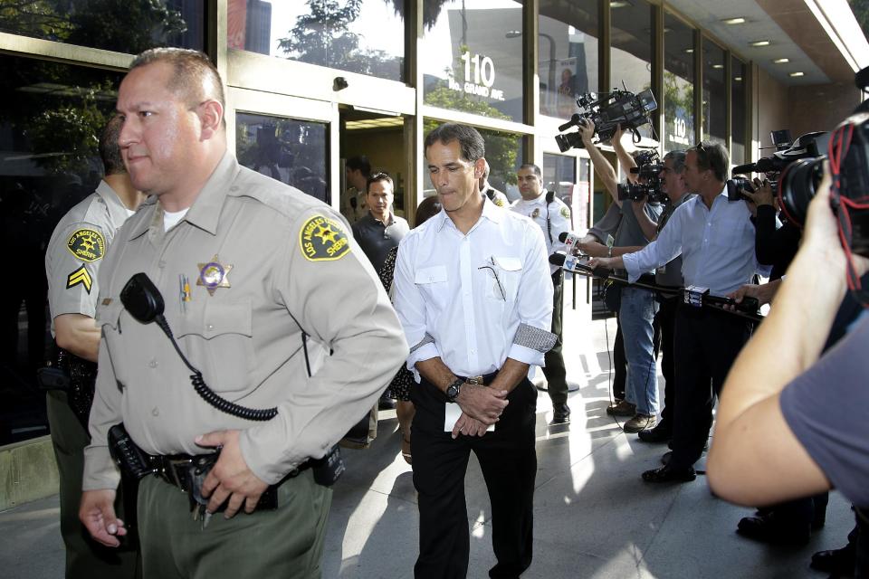 CORRECTS NAME TO GREGG BARDEN, INSTEAD OF GREG BARDEN Jury foreman Gregg Barden, center, is escorted to the interview area outside a courthouse on Wednesday, Oct. 2, 2013, in Los Angeles. The jury cleared AEG Live of negligence in a case that attempted to link the death of Michael Jackson to the company that promoted his ill-fated comeback shows. (AP Photo/Jae C. Hong)