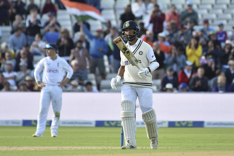 India's Cheteshwar Pujara celebrates after reaching half century during the third day of the fifth cricket test match between England and India at Edgbaston in Birmingham, England, Sunday, July 3, 2022. (AP Photo/Rui Vieira)