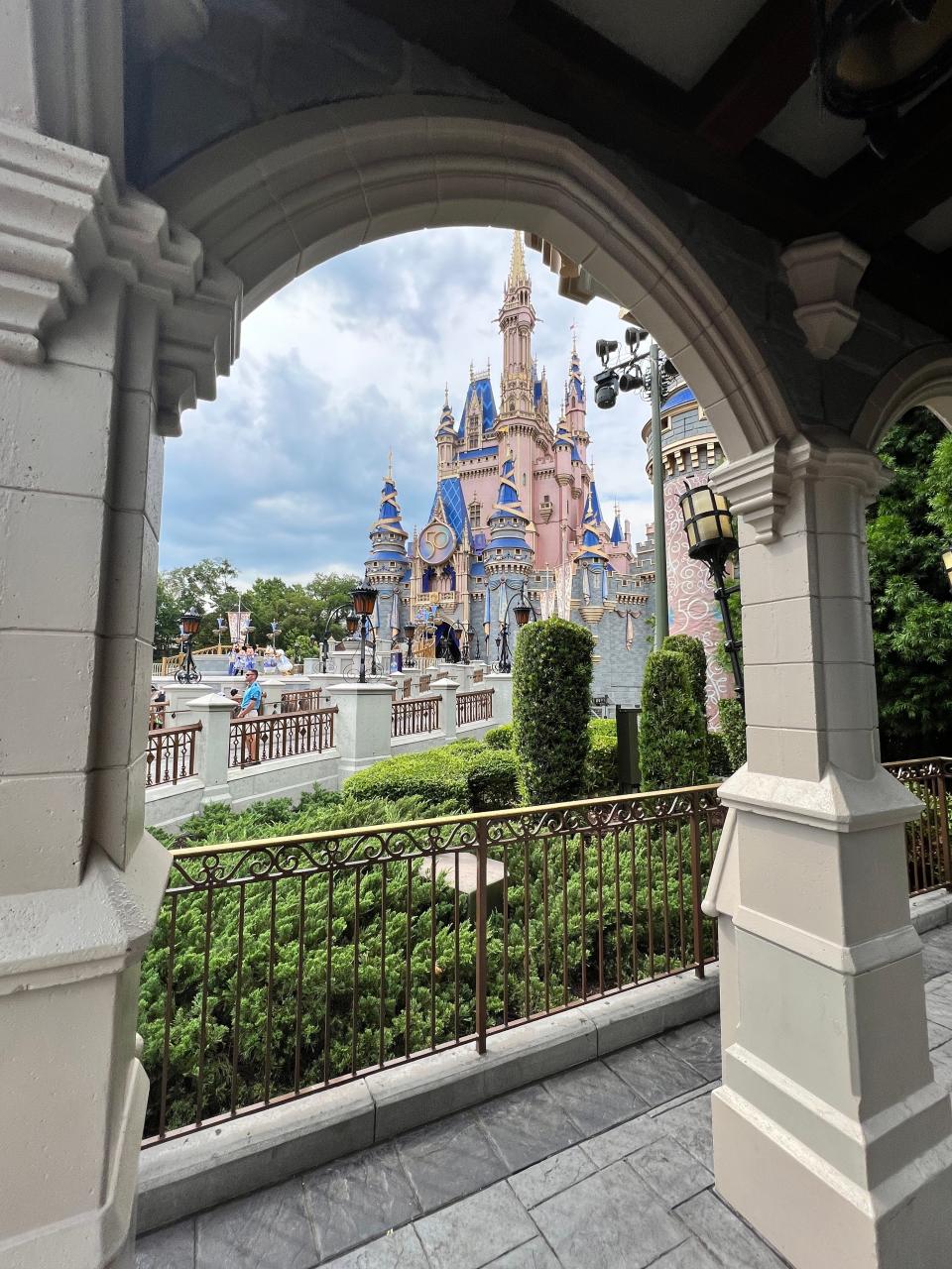 Cinderella Castle is framed in an archway at Magic Kingdom.