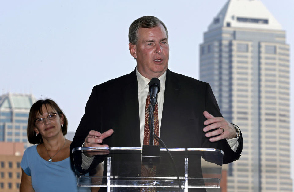 Indianapolis Mayor Greg Ballard talks the plans for the city to bid for the NFL football's 2018 Super Bowl as Allison Melangton, left, chair the 2018 Super Bowl Bid Committee, watches during an announcement in front of the downtown skyline in Indianapolis, Friday, Aug. 30, 2013. (AP Photo/Michael Conroy)