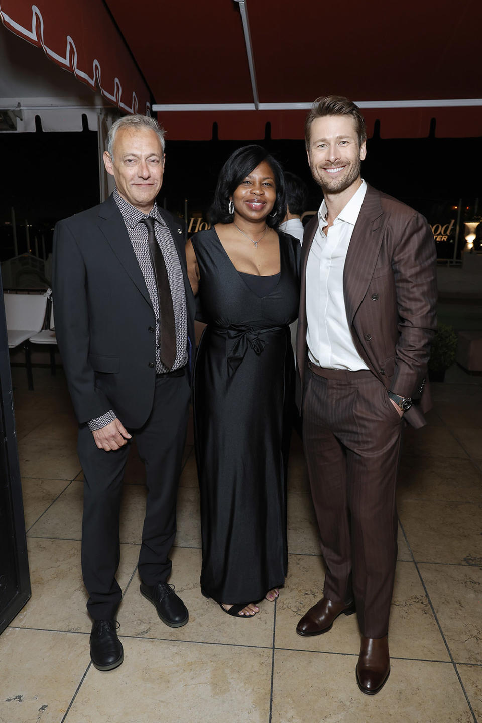 (L-R) Maer Roshan, Co-Editor-in-Chief, The Hollywood Reporter, Nekesa Mumbi Moody, Co-Editor-in-Chief, The Hollywood Reporter and Glen Powell attend THR Power Stylists presented by Instagram at Sunset Tower Hotel on March 27, 2024 in Los Angeles, California.