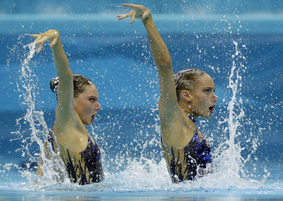 Jenna Randall and Olivia Federici compete during the women's duet synchronized swimming free routine at the Aquatics Centre in the Olympic Park during the 2012 Summer Olympics in London, Monday, Aug. 6, 2012. (AP Photo/Michael Sohn)