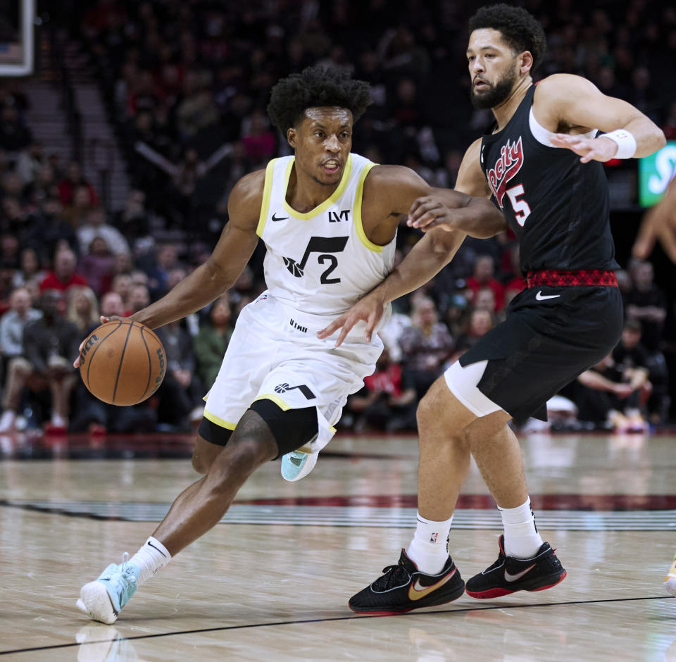 Utah Jazz guard Collin Sexton, left, drives around Portland Trail Blazers guard Skylar Mays during the second half of an NBA basketball game in Portland, Ore., Thursday, Dec. 14, 2023. (AP Photo/Craig Mitchelldyer)