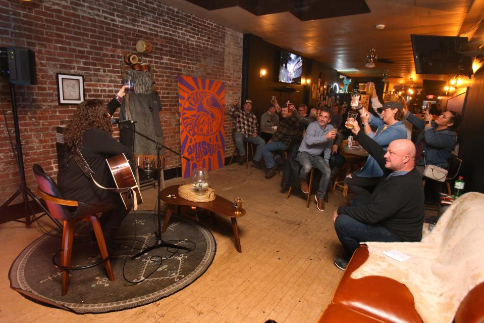 Tawnya Reynolds, left, engages with the crowd during her March 31 performance at Downtownhecks Tap Room in Massillon. Reynolds appeared on u0022The Voiceu0022 television show in 2013, advancing to the top 32 of the singing competition.