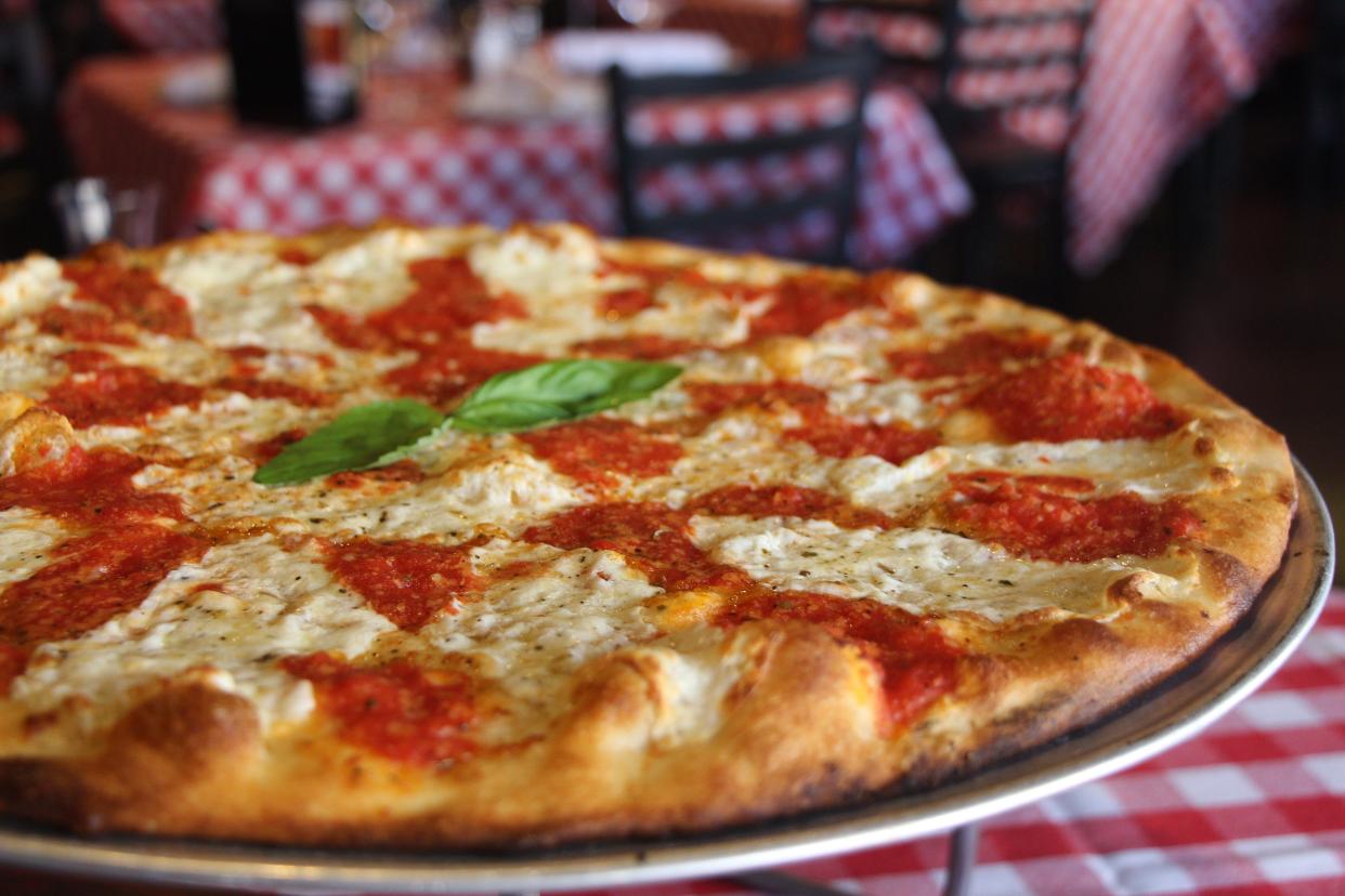 Grimaldi's traditional pizza is topped with a proprietary tomato sauce, fresh mozzarella, basil and the national chain's signature cheese-and-spice mix.