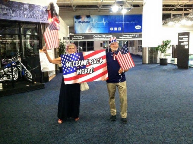 Christa Lorge (left) and Jack Lorge (right) welcome daughter Ingrid Kaat home to the U.S.