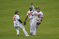 Baltimore Orioles right fielder Ryan McKenna, left, center fielder Cedric Mullins, center, and left fielder Austin Hays celebrate after defeating the New York Yankees 10-6 during a baseball game, Sunday, May 16, 2021, in Baltimore. (AP Photo/Julio Cortez)