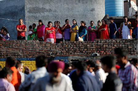 People gather at the site of an accident after a commuter train traveling at high speed ran through a crowd of people on the rail tracks on Friday, in Amritsar, India, October 20, 2018. REUTERS/Adnan Abidi