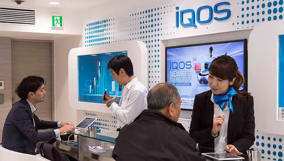 People in an iQOS store in Japan