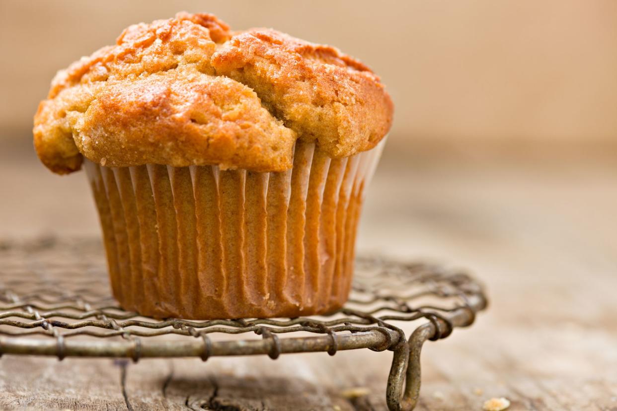 An extreme close up edge on view of a pumpkin muffin sitting on Grandma's 1800's vintage French wire cooling rack.