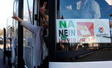 A Kurdish woman flashes a victory sign as she arrives with a group of some 30 Turks of Kurdish descent to vote at the Turkish consulate in Huerth near Cologne, Germany March 27, 2017. REUTERS/Wolfgang Rattay