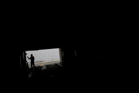 A man walks at parking garage during a blackout in Caracas