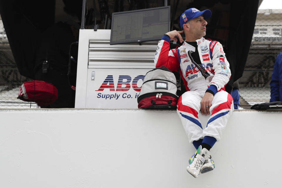 IndyCar driver Tony Kanaan, of Brazil, sits on the pit wall during auto racing testing at the Indianapolis Motor Speedway in Indianapolis, Wednesday, April 24, 2019. (AP Photo/Michael Conroy)