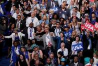 Delegates hold hands and sway together during music break after the segment for fallen police officers at the Democratic National Convention in Philadelphia, Pennsylvania, U.S. July 28, 2016. REUTERS/Rick Wilking.