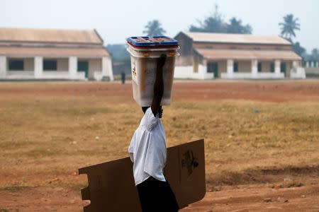 A man carries electoral material prior to the start of the second round of presidential and legislative elections in the mostly Muslim PK5 neighbourhood of Bangui, Central African Republic, February 14, 2016. REUTERS/Siegfried Modola