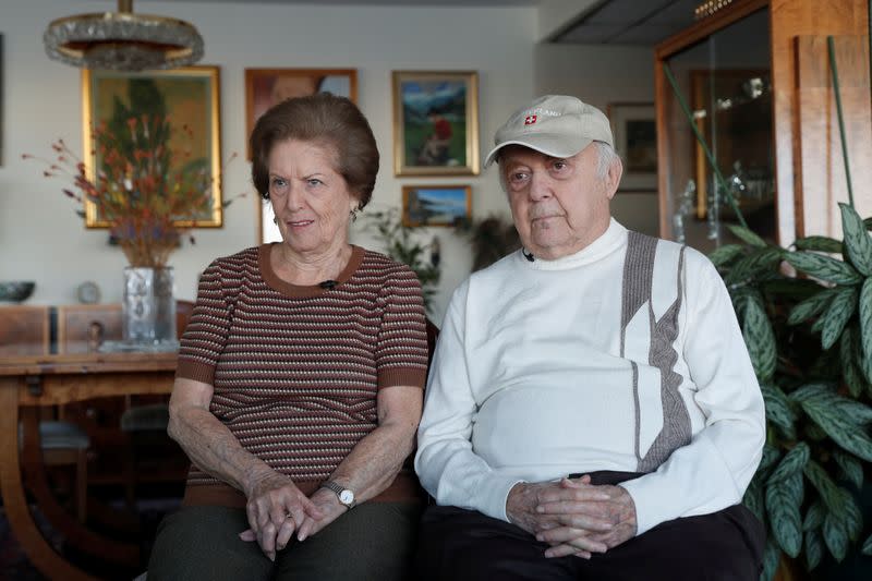 Lea Evron and her husband Yehuda listen to a question during an interview at their apartment in the Queens borough of New York