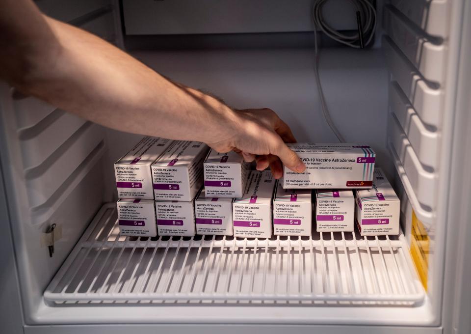 Staff member handles AstraZeneca COVID-19 vaccines in storage at Region Hovedstaden's Vaccine Center, Copenhagen (via REUTERS)