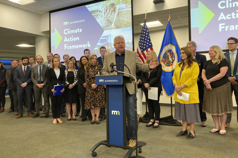 CORRECTS DATE TO JAN. 30, 2023, NOT JAN. 23, 2023 - FILE - Minnesota Democratic Gov. Tim Walz rolls out a framework for fighting climate change that shows his proposed direction on the environment if he wins a second term, a sweeping plan that would slash carbon emissions and speed the switchover to electric vehicles, in Eagan, Minn., Sept. 16, 2022. The Minnesota Court of Appeals on Monday, Jan. 30, 2023, upheld the state's “Clean Car Rule,” which ties the state's vehicle emission standards to California regulations, accepting assurances that California's planned phaseout of gasoline-powered cars will not automatically apply in Minnesota. (AP Photo/Steve Karnowski, File)
