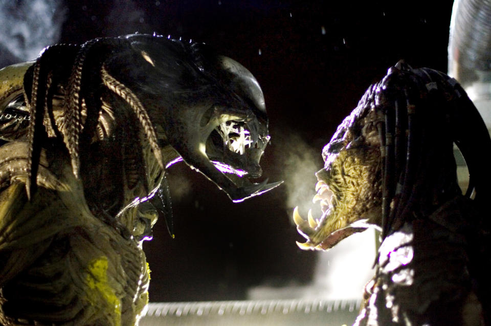 Two Predator characters face off in a tense moment from the film series