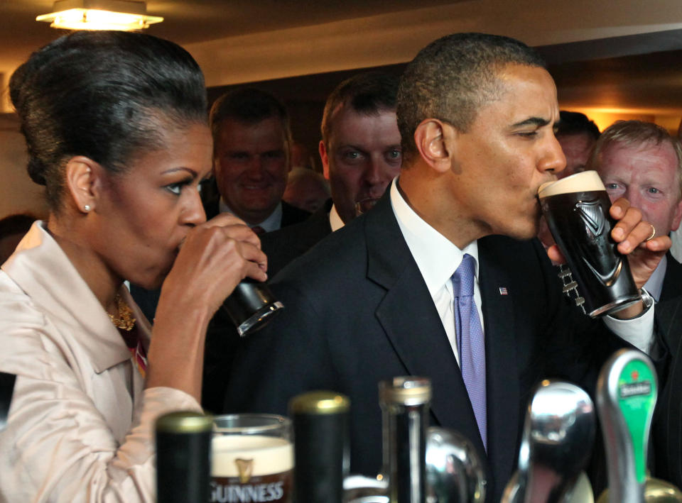 President Barack Obama And First Lady Michelle Obama Enjoy A Pint Of Guinness At Hayes Bar In His Ancestral Home Moneygall, Co Offaly During President Obama'S Visit To Ireland. (Photo by Mark Cuthbert/UK Press via Getty Images)