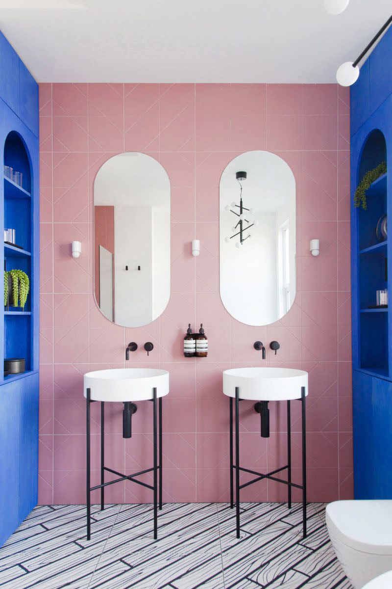 <p>A bathroom is the perfect place to have a little fun with pattern, shape, and color. And there's no place better to look for fun bathroom inspiration than 2LG Studio's portfolio. In this bathroom, they assert a strong sense of symmetry with double sinks featuring round vanity and linear frame. These two shapes are played up in the mock wood floor tiles and oval sinks. </p>