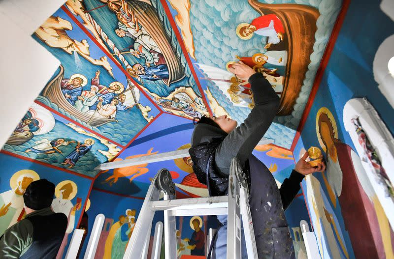 Georgian restorers work on frescoes at the chapel of a mobile Georgian Orthodox monastery in Vlissingen