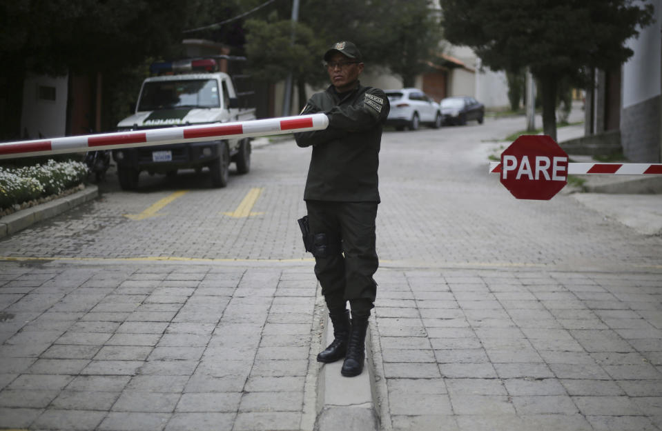 A police officer stands at the entrance leading to the residence of Mexico’s ambassador to help make sure nine former officials from the government of deposed Bolivian President Evo Morales, who have taken refuge inside, do not leave the country, in La Paz, Bolivia, Monday, Dec. 30, 2019. Bolivia’s interim government is expelling the top Mexican and Spanish diplomats in the country over an alleged attempt by members of Bolivia’s former government to leave refuge in the Mexican embassy with Spanish help and flee the country. (AP Photo/Luis Gandarillas)