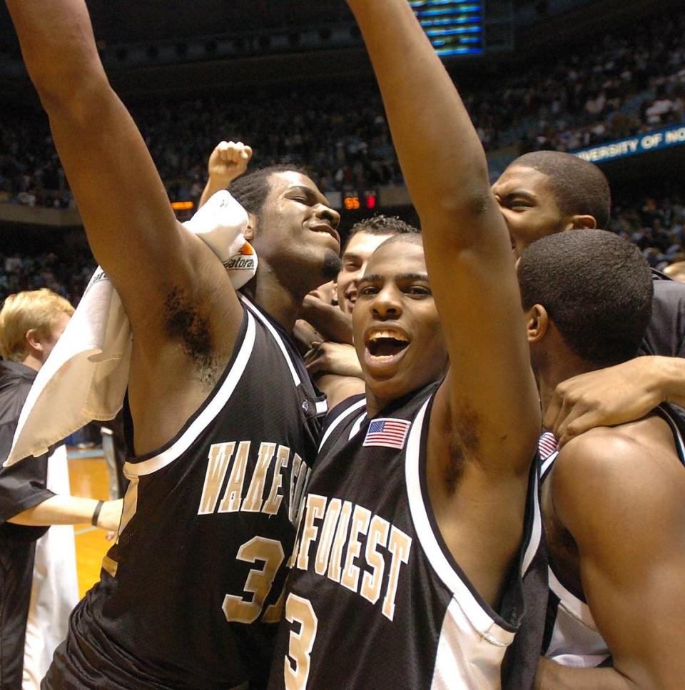 12/20/03 Wake’s Eric Williams (#31) and freshman Chris Paul celebrate at center court of the Dean Smith Center after defeating the Tar Heels, in 3 overtimes, 119-114. It was Paul’s first-ever ACC game, as well as the first one for UNC coach Roy Williams.