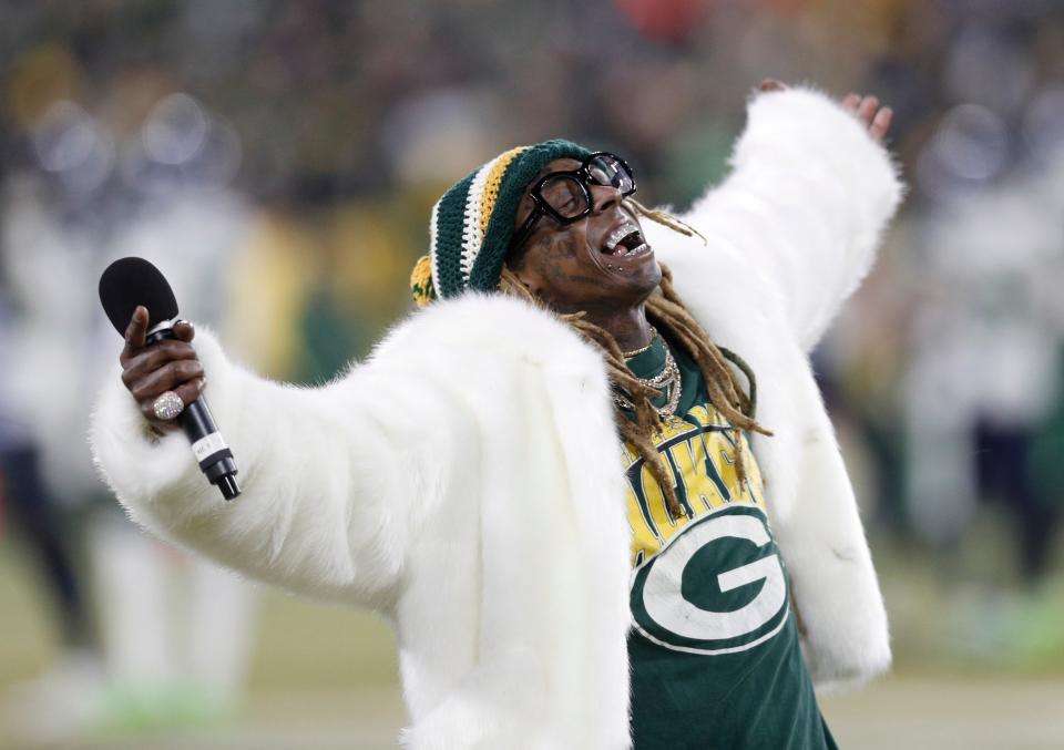 Lil Wayne addresses the crowd in the second half of a NFC Divisional Round playoff football game between the Green Bay Packers and Seattle Seahawks at Lambeau Field in 2019.