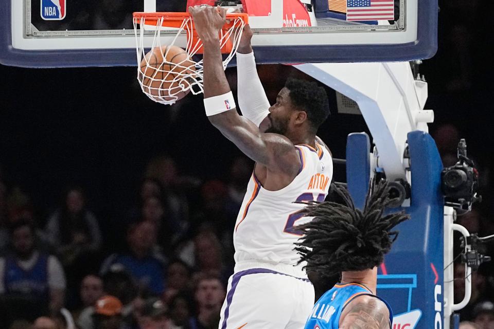 Phoenix Suns center Deandre Ayton (22) dunks in front of Oklahoma City Thunder forward Jaylin Williams in the first half of an NBA basketball game on Sunday, April 2, 2023, in Oklahoma City.