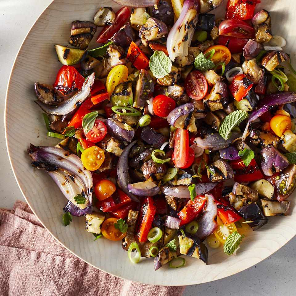 <p>This easy grilled eggplant salad is the healthy side dish you'll want to serve all summer long. It comes together in just 25 minutes and can be served warm or at room temperature, so it's equally suited to casual parties and weeknight dinners. The combination of eggplant, cherry tomatoes, red peppers, red onions and fresh herbs makes for a salad that's full of bright flavors and colors. Serve it with grilled chicken or fish or as part of a vegetarian mezze platter with dips like hummus and pita bread. <a href="https://www.eatingwell.com/recipe/273918/grilled-eggplant-salad/" rel="nofollow noopener" target="_blank" data-ylk="slk:View Recipe;elm:context_link;itc:0;sec:content-canvas" class="link ">View Recipe</a></p>