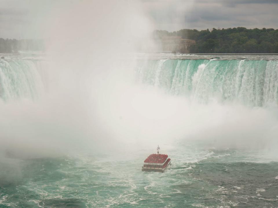 Ein Boot nähert sich den Horseshoe Falls an den Niagarafällen an einem bewölkten Tag