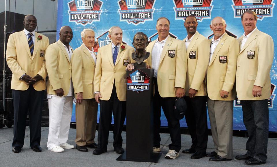 FILE - In this Aug. 8, 2009, file photo, Ralph Wilson Jr., fourth from left, owner of the Buffalo Bills, poses with his bust and former Buffalo Bills players, from left, Bruce Smith, Thurman Thomas, Marv Levy, Joe DeLamielleure, James Lofton, Billy Shaw and Jim Kelly during the Pro Football Hall of Fame induction ceremony at the Pro Football Hall of Fame in Canton, Ohio. Bills owner Wilson Jr. has died at the age of 95 at his home in Grosse Pointe Shores, Mich. NFL.com says team president Russ Brandon announced his death at the league's annual meeting in Orlando, Fla., Tuesday, March 25, 2014. He was one of the original founders of the American Football League and owned the Bills for the last 54 years. (AP Photo/Tony Dejak, File)