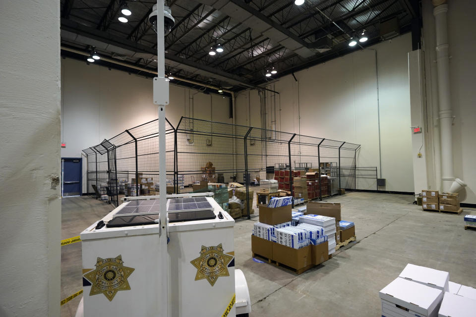 A security camera is positioned to monitor a cage where mail-in ballots will be stored after arriving at the Harris County election headquarters Tuesday, Sept. 29, 2020, in Houston. With a record 16 million registered voters in Texas, election officials in places such as Harris County — which includes Houston and is home to more than 2.4 million voters — have taken novel approaches to protect the electorate. (AP Photo/David J. Phillip)