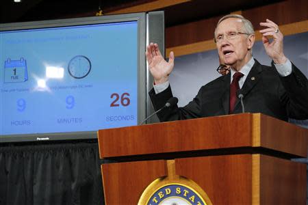 U.S. Senate Majority Leader Harry Reid (D-NV) stands next to a countdown clock as he speaks at a news conference at the U.S. Capitol in Washington, September 30, 2013. REUTERS/Jonathan Ernst