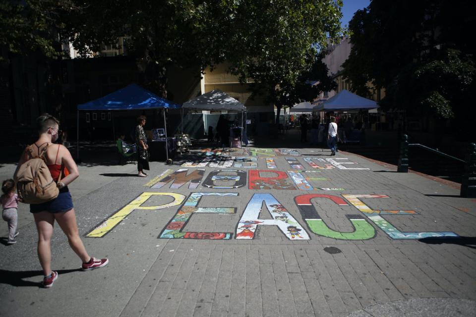 <span class="caption">People look at the More Justice More Peace Mural created by 17 artists to raise awareness of injustices suffered by Black and Indigenous people in Victoria, B.C., in August 2020.</span> <span class="attribution"><span class="source">THE CANADIAN PRESS/Chad Hipolito</span></span>