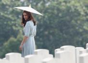 <p>Kate Middleton walks through Kranji Commonwealth War Cemetery in Singapore, shielded by a parasol.<br></p>