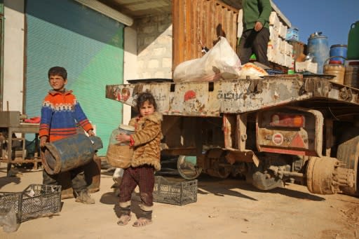 Syrians load their belongings onto a truck as they prepare to flee the village of Kafr Nuran in the northern province of Aleppo