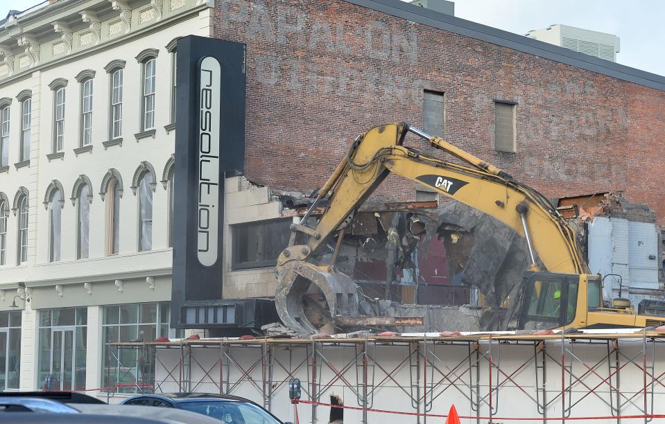 An excavator tears down the former Greyhound bus station in Erie on Tuesday. It last served as Resolution night club and was demolished as part of the Erie Downtown Development Corp.'s redevelopment of properties on North Park Row on Perry Square.