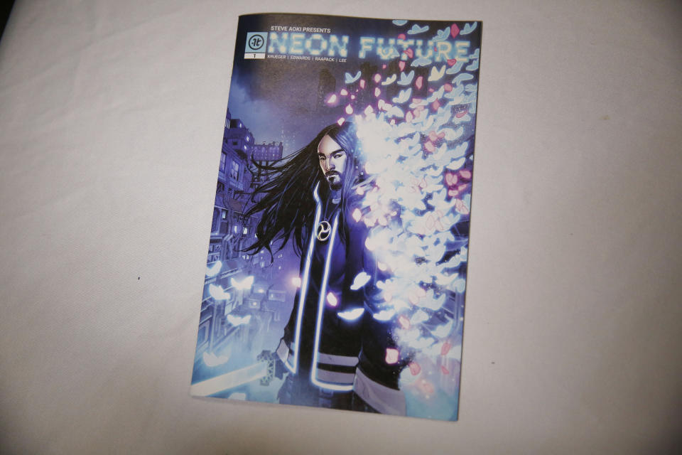 A copy of Steve Aoki's new comic book "Neon Future" is seen at his signing at Multiverse Corps. Comics on Thursday, May 2, 2019, in Miami. Aoki imagines a future where humans live in harmony with technology. The story is set roughly 30 years from now in a United States that has outlawed advanced technology. A civil war is brewing between people who have integrated technology into their bodies and those who have not. (AP Photo/Brynn Anderson)