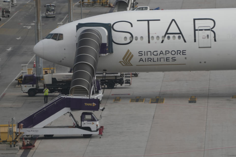 The Boeing 777-300ER aircraft of Singapore Airlines, is parked after the SQ321 London-Singapore flight, that encountered severe turbulence, at Suvarnabhumi International Airport, near Bangkok, Thailand, Wednesday, May 22, 2024. The Singapore Airlines flight descended 6,000 feet (around 1,800 meters) in about three minutes, the carrier said Tuesday. A British man died and authorities said dozens of passengers were injured, some severely. (AP Photo/Sakchai Lalit)