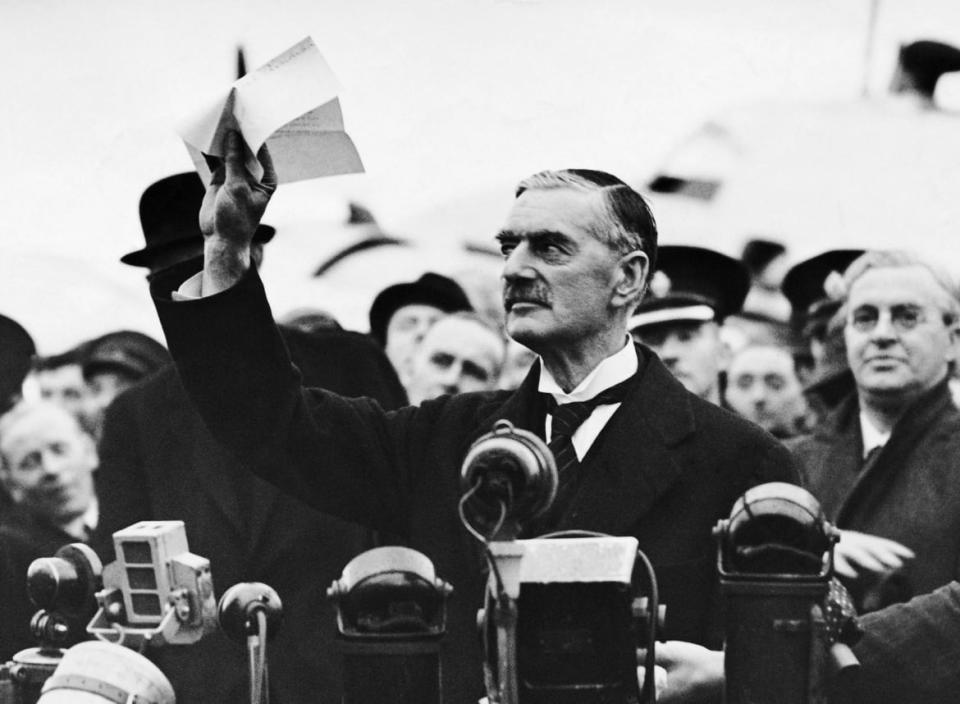 <div class="inline-image__caption"><p>British Prime Minister Neville Chamberlain speaking to a crowd on his arrival at Heston Airport from Munich, where he had met Hitler, Mussolini, and Daladier to settle the question of the Czecho-Slovak dispute in 1938.</p></div> <div class="inline-image__credit">George Rinhart/Corbis via Getty</div>