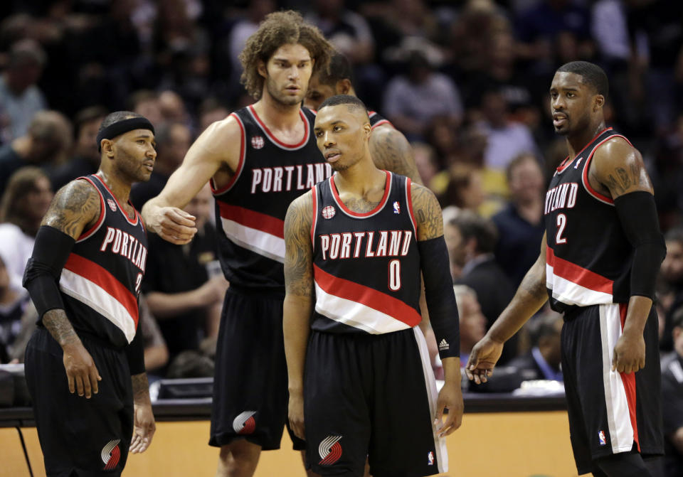 Portland Trail Blazers' Damian Lillard (0) and teammates wait to enter the game following a timeout during the first half of Game 1 of a Western Conference semifinal NBA basketball playoff series against the San Antonio Spurs, Tuesday, May 6, 2014, in San Antonio. (AP Photo/Eric Gay)