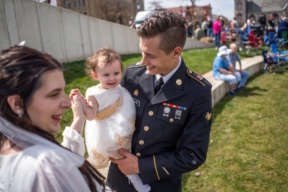 Madalyn Maynard, left, of Defiance, Ohio, dances with her daughter Novaly Maynard and her soon-to-be-husband Army Reserve member Deven Maynard, of Defiance, Ohio, as they wait to get married during the Elope at the Eclipse event at the Frost Kalnow Amphitheater in Tiffin, Ohio on Monday, April 8, 2024. Over one hundred couples and their families gathered to be married or renew their vows during the totality of the eclipse event.