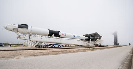 A SpaceX Falcon 9 rocket with the company's Crew Dragon spacecraft onboard is seen as it is rolled out of the horizontal integration facility at Launch Complex 39A as preparations continue for the Demo-1 mission at the Kennedy Space Center in Cape Canaveral, Florida, U.S., February 28, 2019. Joel Kowsky/NASA/Handout via REUTERS