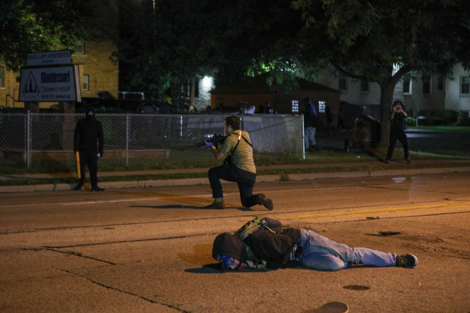 A man on the ground was shot in the chest as clashes between protesters and armed civilians who protect the streets of Kenosha against the arson during the third day of protests over the shooting of a black man Jacob Blake by police officer in Wisconsin, United States on August 25, 2020. (Tayfun Coskun/Anadolu Agency via Getty Images)