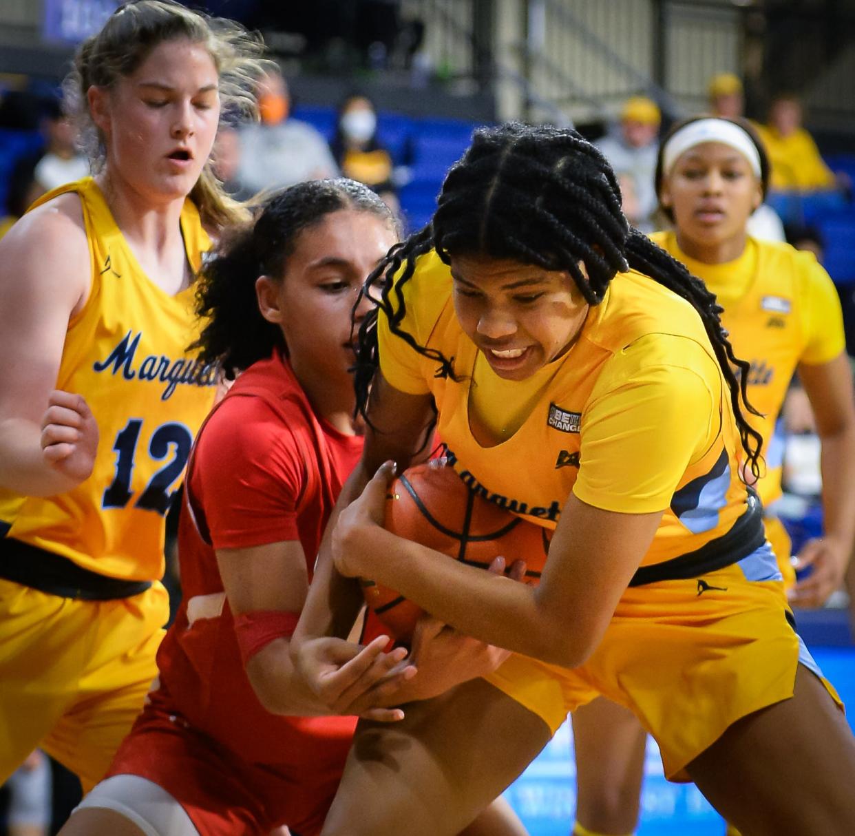 Marquette Golden Eagles forward Charia Smith (5) and Saint Francis Red Flash forward Aaliyah Moore (1) battle for a ball under the basket Sunday, November 27, 2022, at the Al McGuire Center in Milwaukee, Wisconsin.
